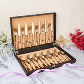 Decorative cutlery gift box with rose gold flatware, styled with floral accents and pastel ribbons.